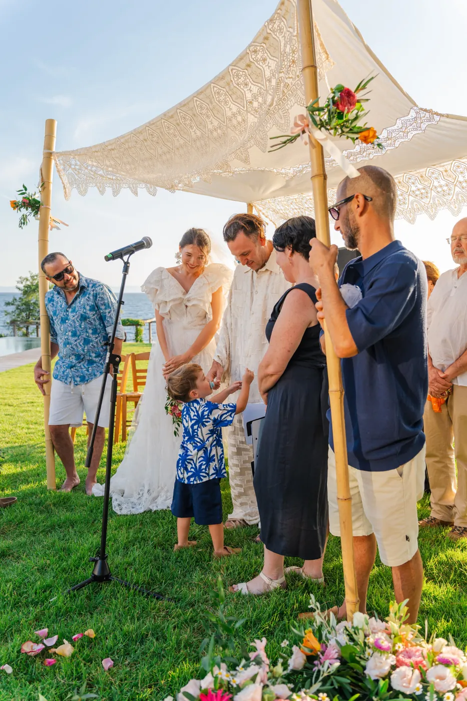 Liran Jakob Rosenfeld with his son at a wedding ceremony by the sea