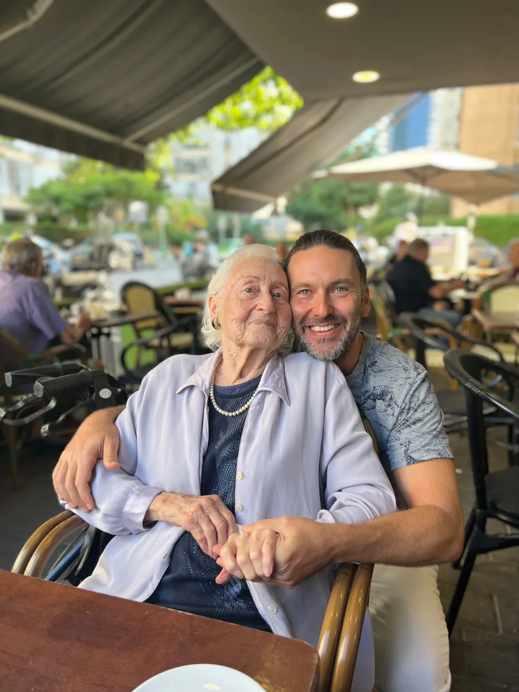 Liran Jakob Rosenfeld sitting with his grandmother, Esther Rosenfeld