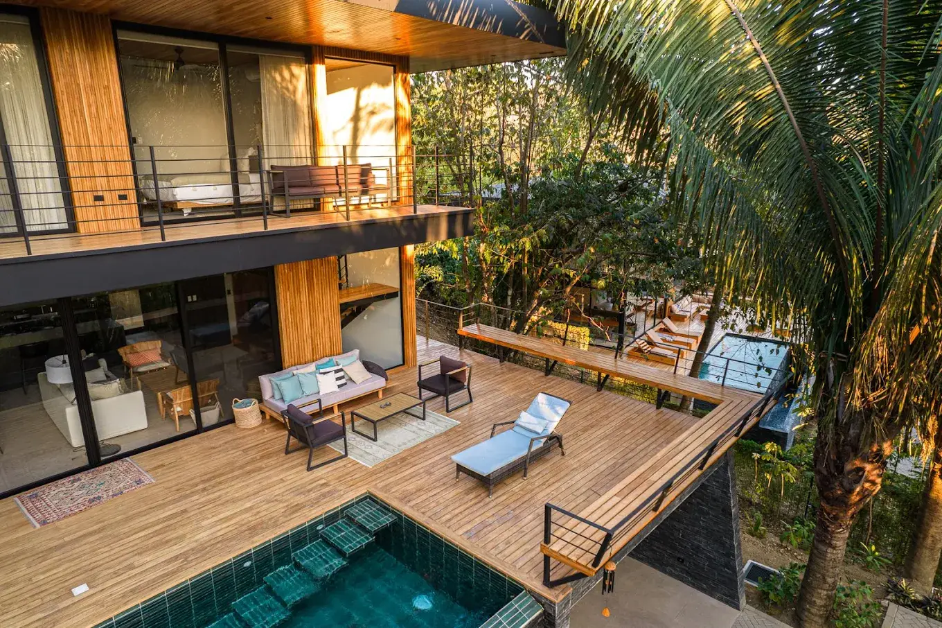 A Yoko Village home and outdoor pool surrounded by palms