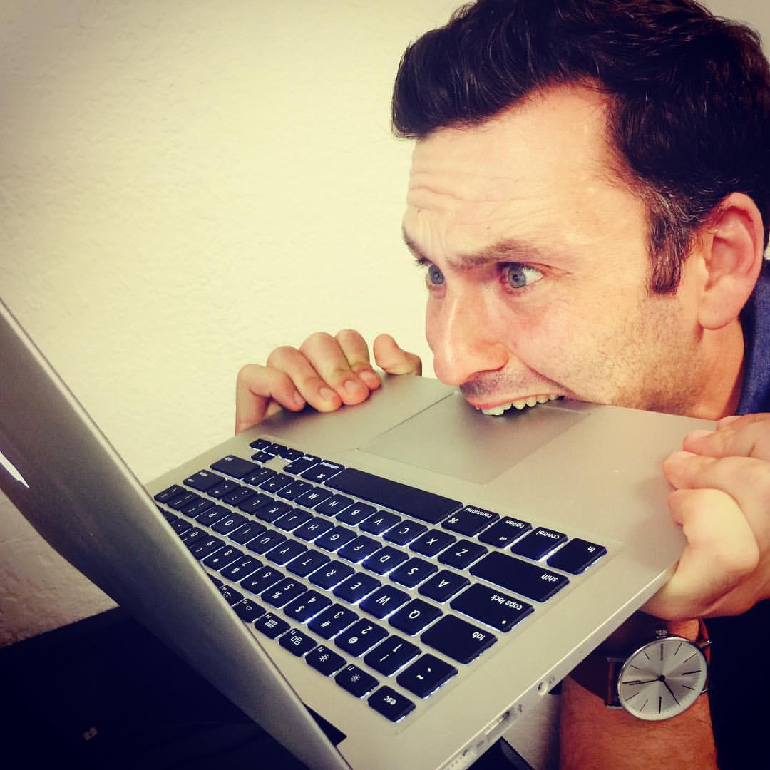 Liran Jakob Rosenfeld pretending to bite a computer in frustration
